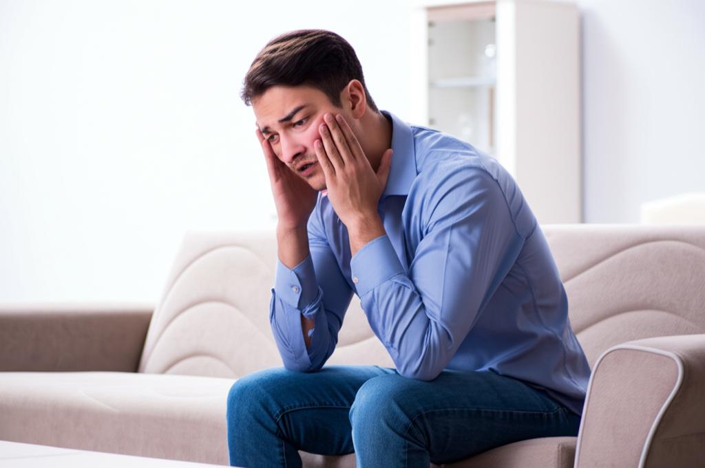 A man sitting alone looking worried, contemplating relationship issues