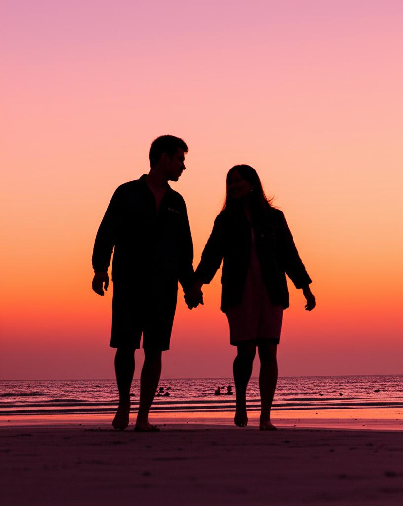 happy couple walking hand in hand on beach at sunset, silhouette, romantic